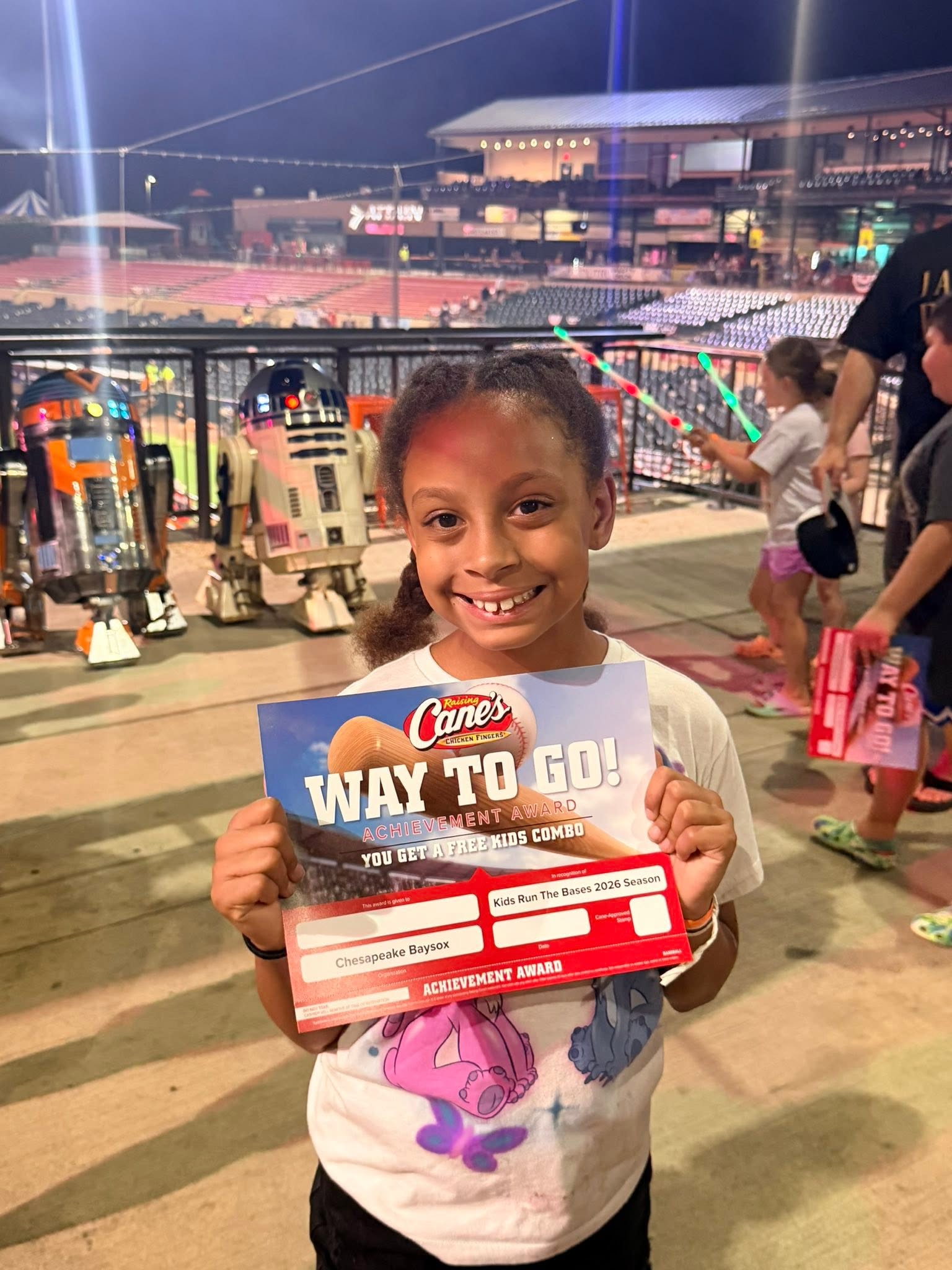 A young Baysox fan with a Kids Run the Bases achievement award